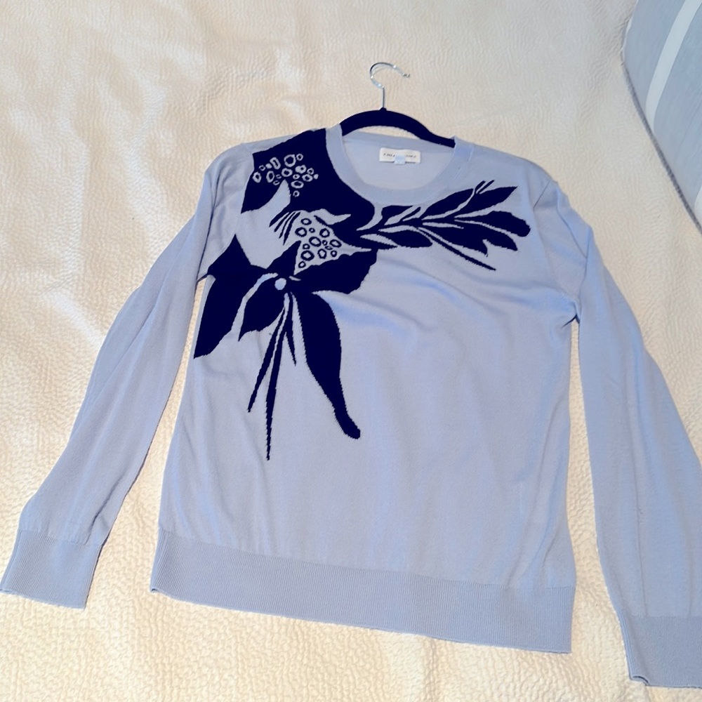 Chloé Stora periwinkle sweater with black floral design.